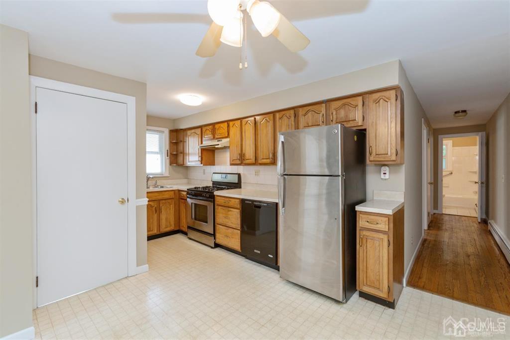 642 Front Street Dunellen, NJ 08812 - Photo 10 of 24 a kitchen with stainless steel appliances granite countertop a refrigerator a sink dishwasher a stove with white cabinets and wooden floor