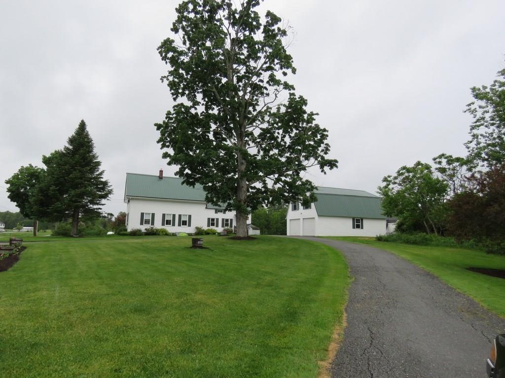 135 Lake Road Levant, ME 04456 - Photo 2 of 35 Front Yard. A large garage with...