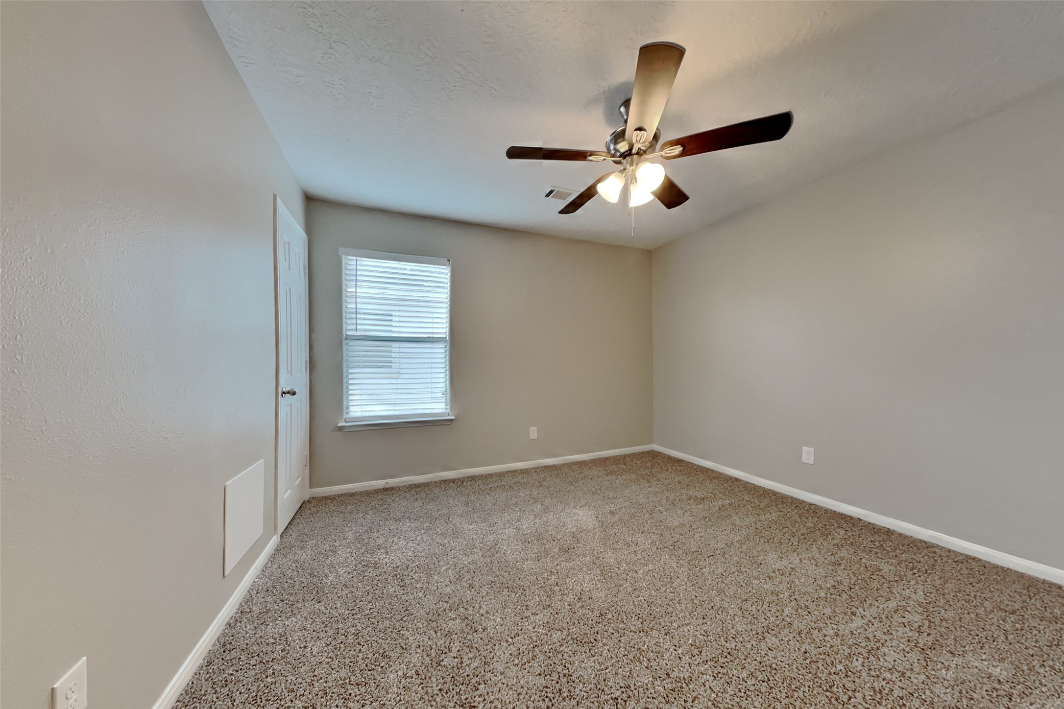 4938 Comal River Loop Spring, TX 77386 - Photo 11 of 14 an empty room with windows and fan