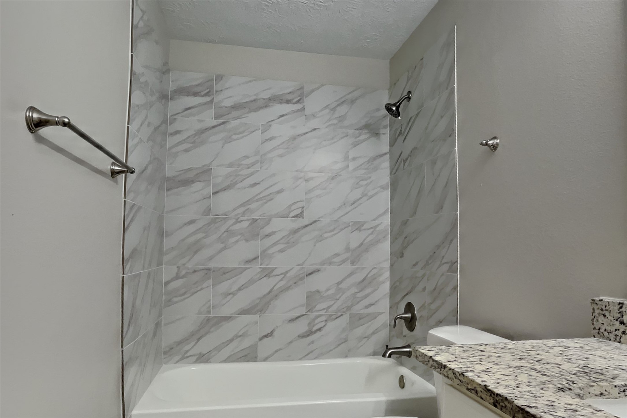 4938 Comal River Loop Spring, TX 77386 - Photo 12 of 14 a bathroom with a granite countertop sink and a bathtub