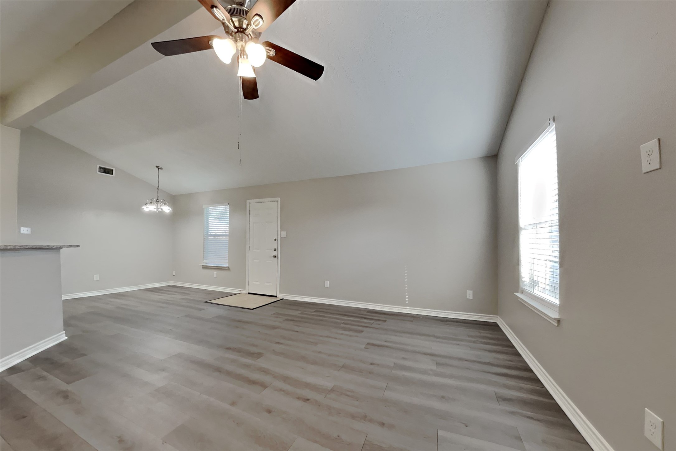 4938 Comal River Loop Spring, TX 77386 - Photo 3 of 14 an empty room with wooden floor ceiling fan and windows