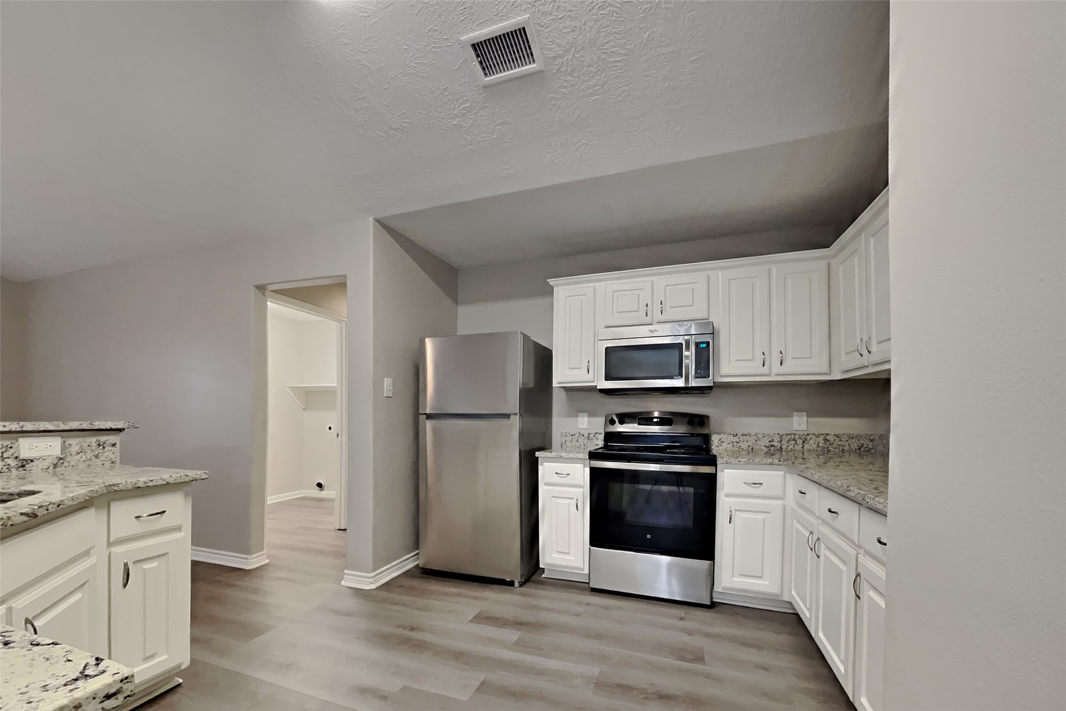 4938 Comal River Loop Spring, TX 77386 - Photo 5 of 14 a kitchen with a refrigerator stove and sink