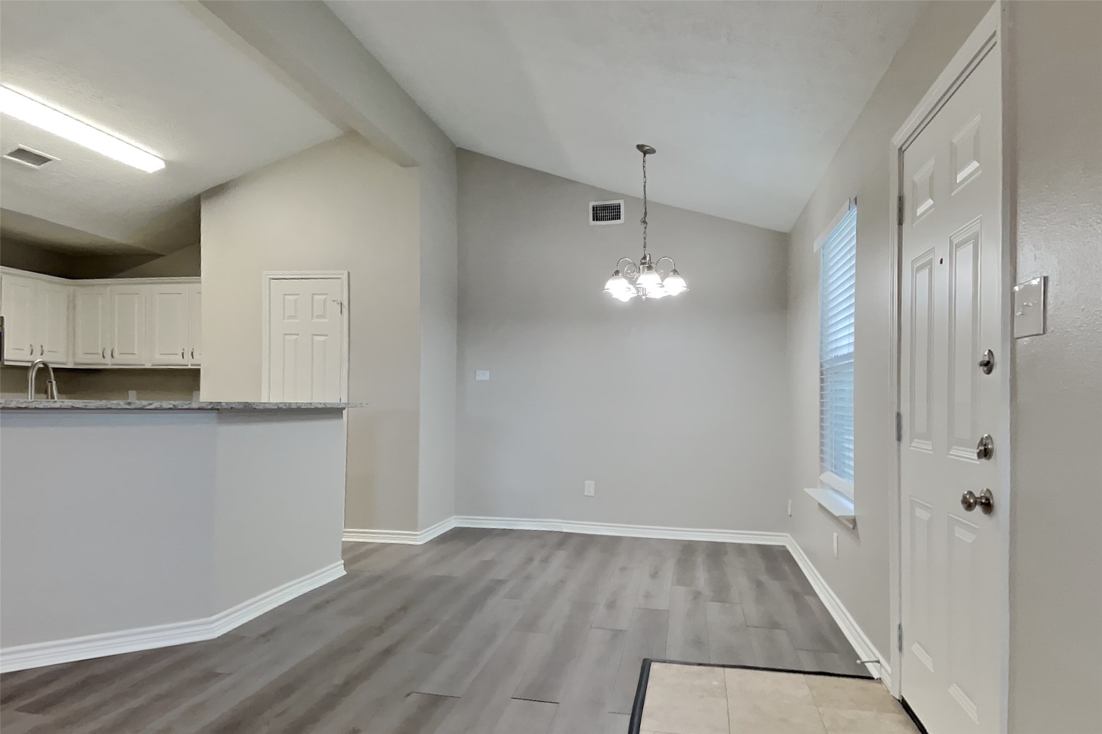 4938 Comal River Loop Spring, TX 77386 - Photo 6 of 14 a view of a kitchen with wooden floor and electronic appliances