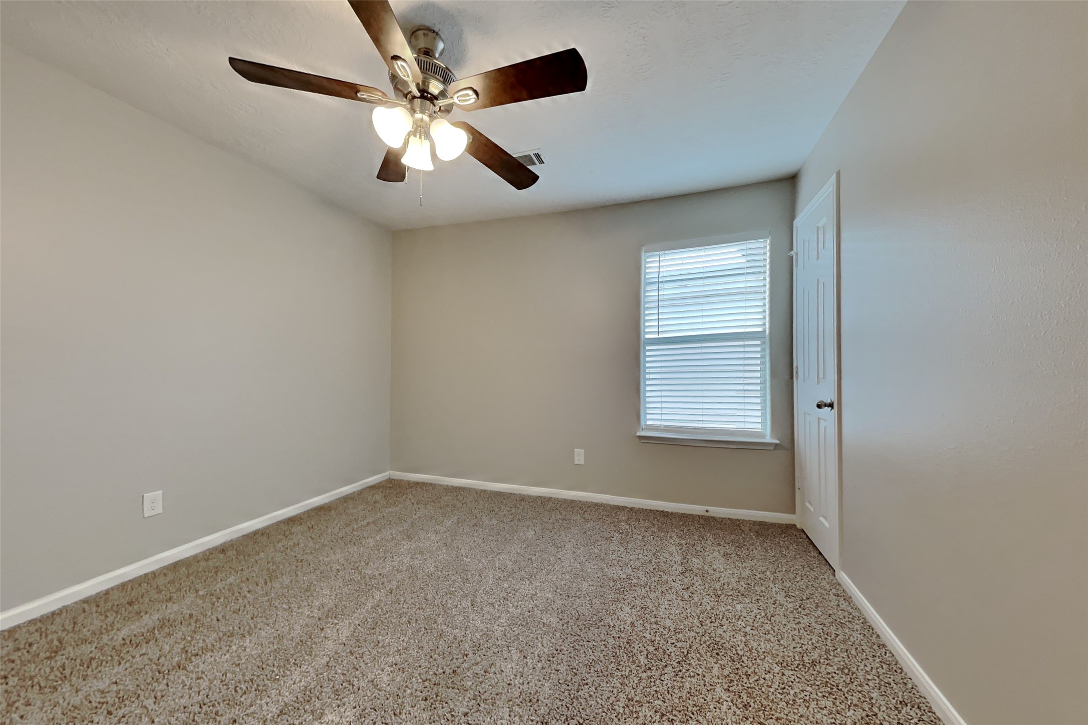 4938 Comal River Loop Spring, TX 77386 - Photo 10 of 14 an empty room with fan and windows
