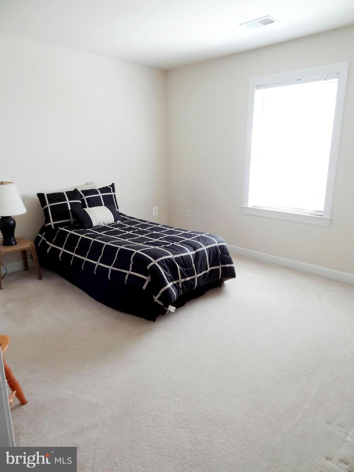 708 Hillmeade Road Edgewater, MD 21037 - Photo 17 of 23 a bed sitting in a room next to a window