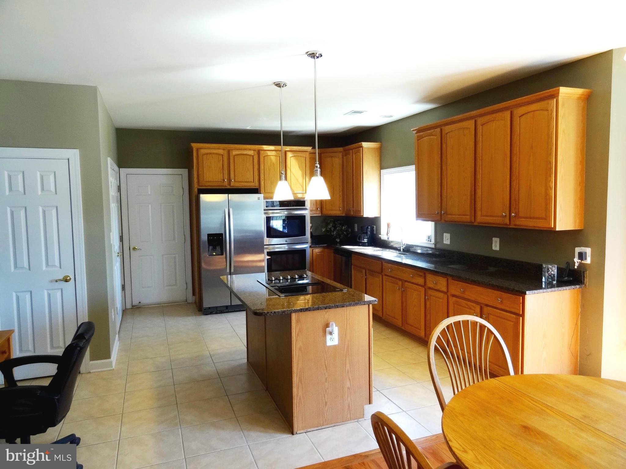708 Hillmeade Road Edgewater, MD 21037 - Photo 3 of 23 a kitchen with stainless steel appliances granite countertop a stove a sink and a refrigerator