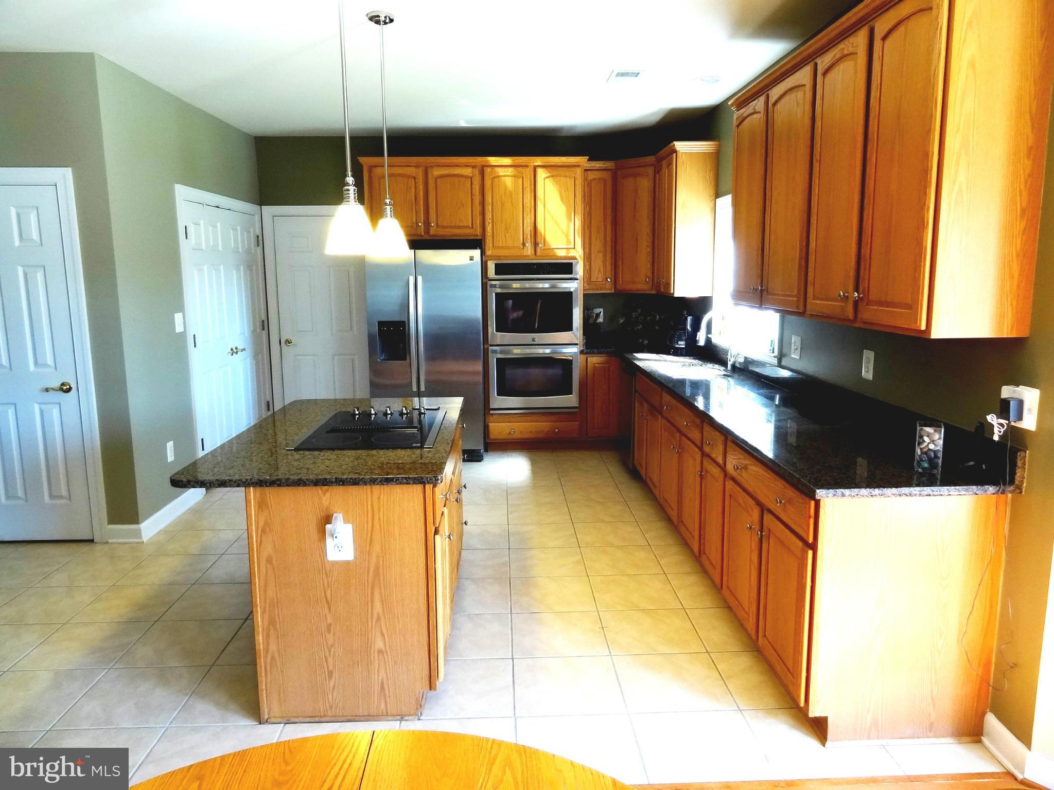 708 Hillmeade Road Edgewater, MD 21037 - Photo 4 of 23 a kitchen with stainless steel appliances granite countertop a sink a stove and a refrigerator