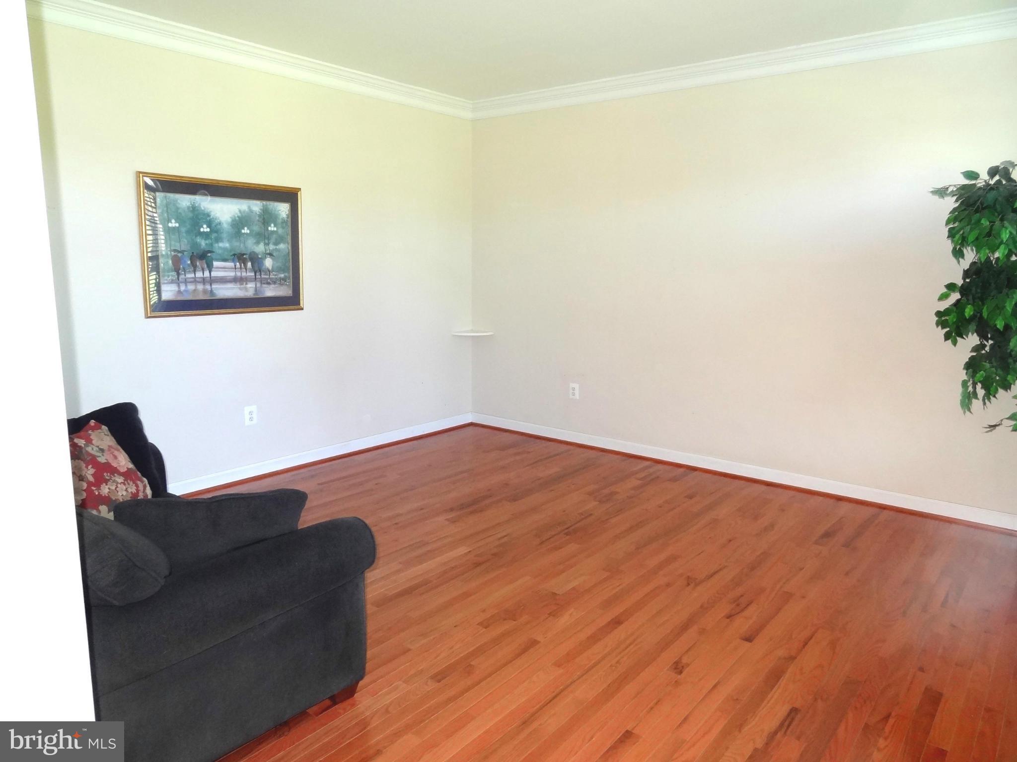 708 Hillmeade Road Edgewater, MD 21037 - Photo 8 of 23 a view of a room with wooden floor and chair