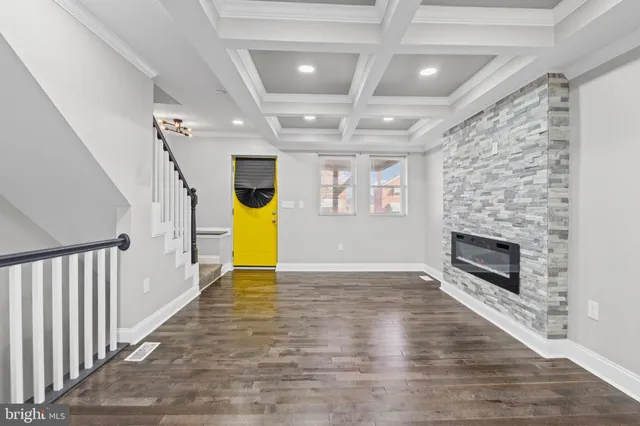 a view of an empty room with a fireplace and a window