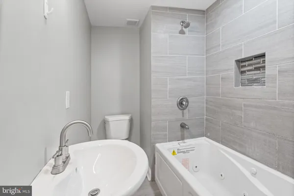 a bathroom with a bathtub and shower