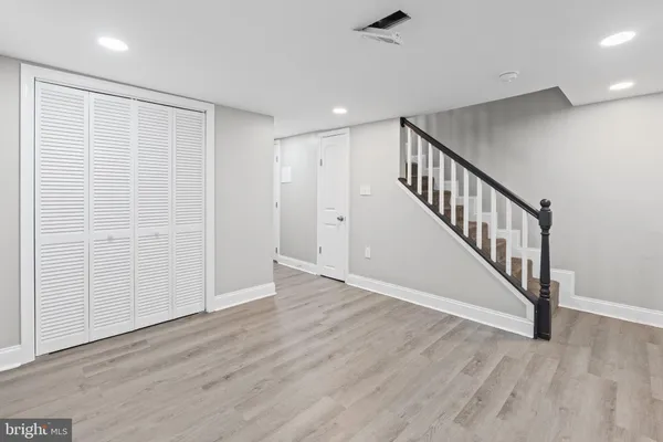 a view of an entryway with wooden floor