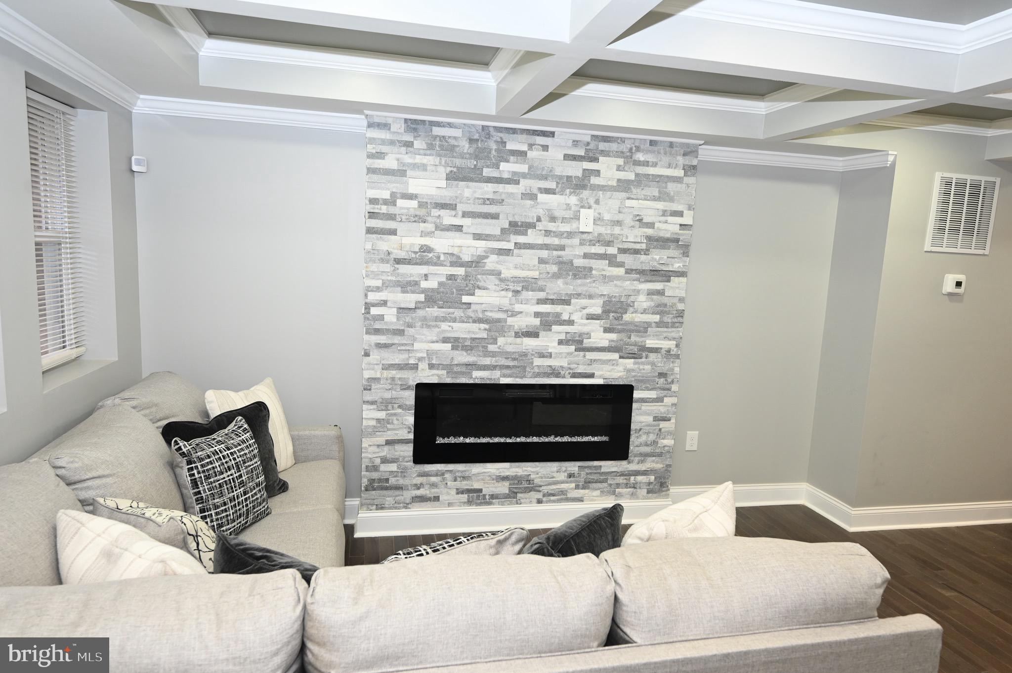 4139 Mountwood Road Baltimore, MD 21229 - Photo 26 of 53 a living room with furniture and a fireplace