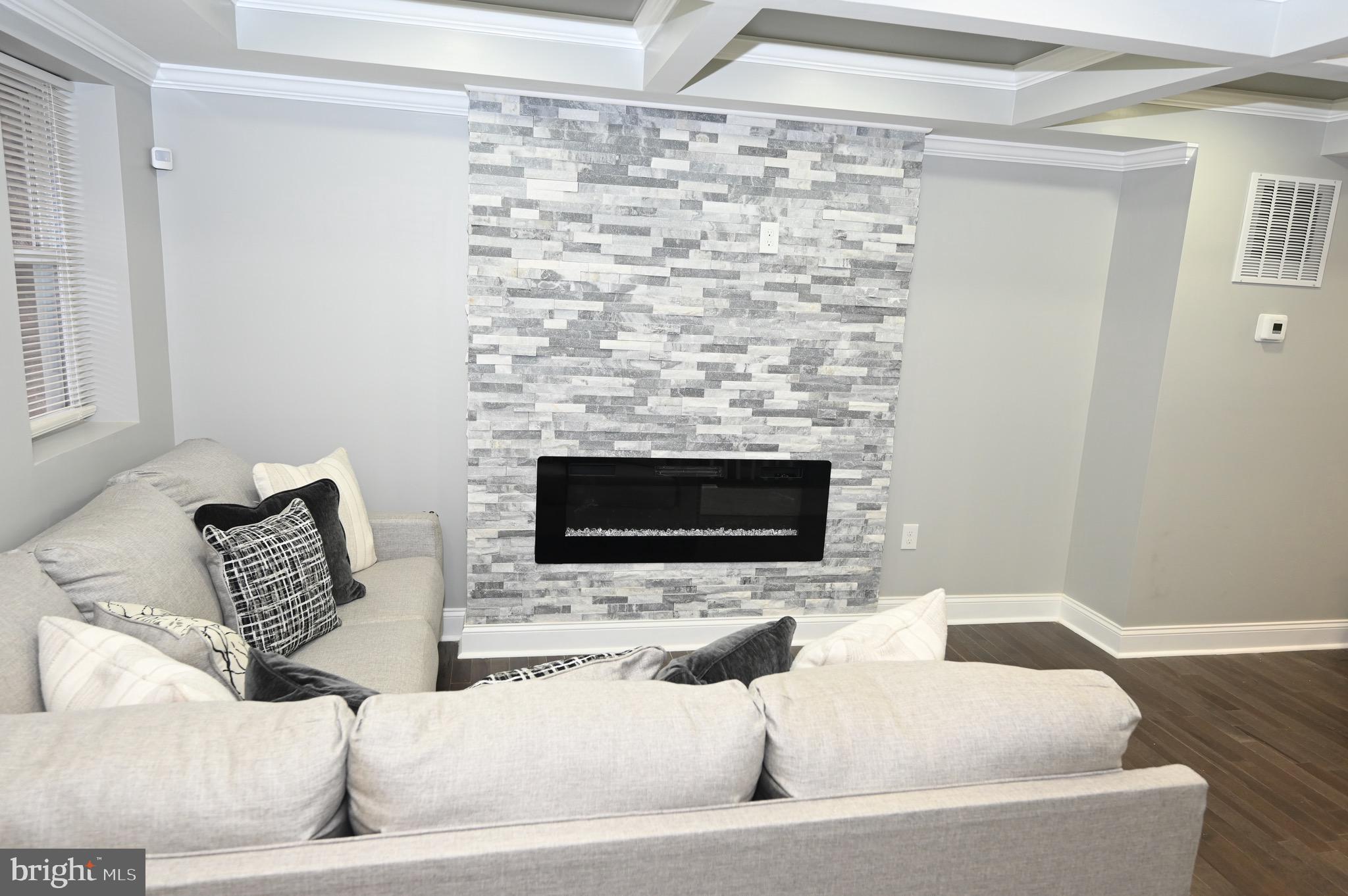 4139 Mountwood Road Baltimore, MD 21229 - Photo 28 of 53 a living room with furniture and a fireplace