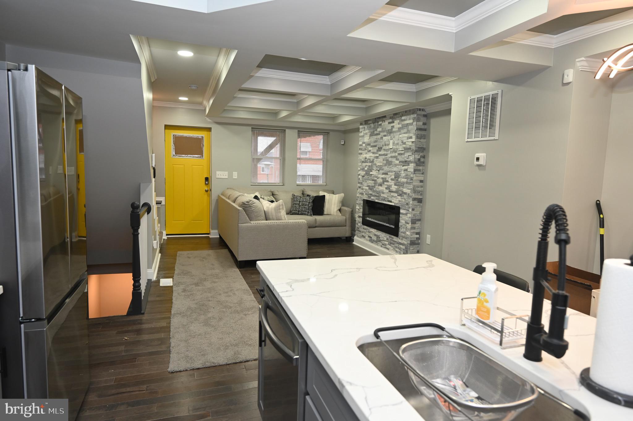 4139 Mountwood Road Baltimore, MD 21229 - Photo 31 of 53 a living room with furniture a fireplace and a flat screen tv