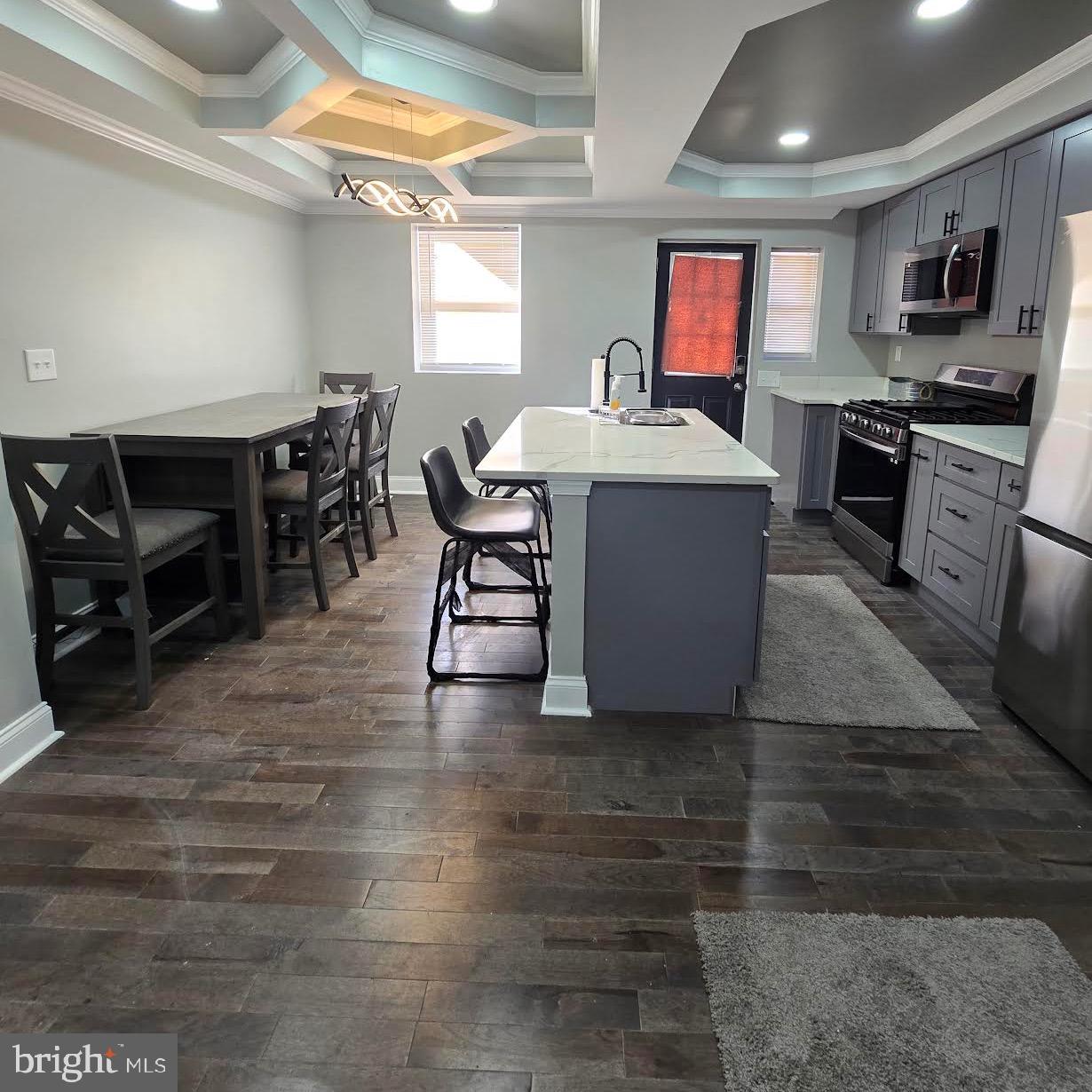 4139 Mountwood Road Baltimore, MD 21229 - Photo 32 of 53 a living room with furniture a flat screen tv and kitchen view