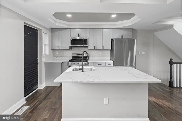 a kitchen with stainless steel appliances a refrigerator sink and microwave