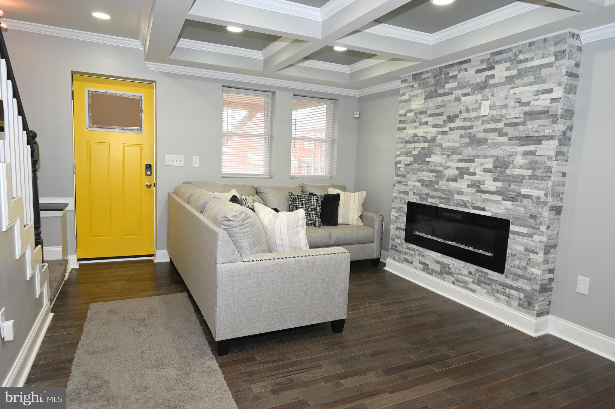 4139 Mountwood Road Baltimore, MD 21229 - Photo 42 of 53 a living room with a fireplace and a rug