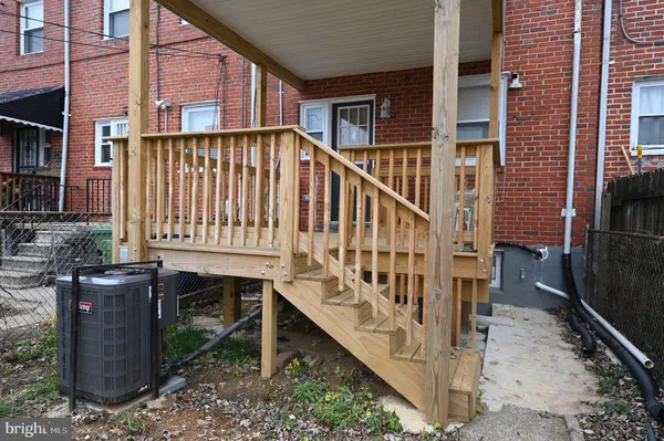 front view of a brick house with a small yard