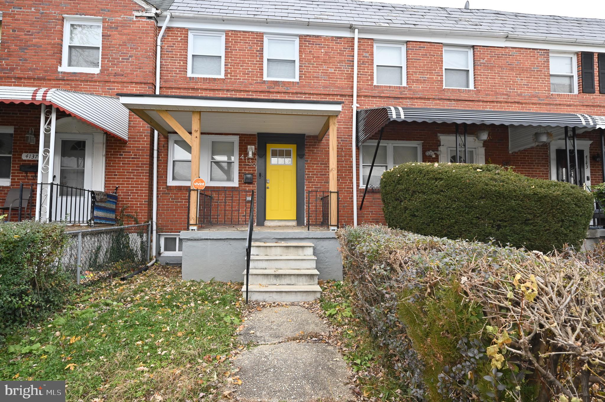4139 Mountwood Road Baltimore, MD 21229 - Photo 47 of 53 front view of a brick house with a small yard