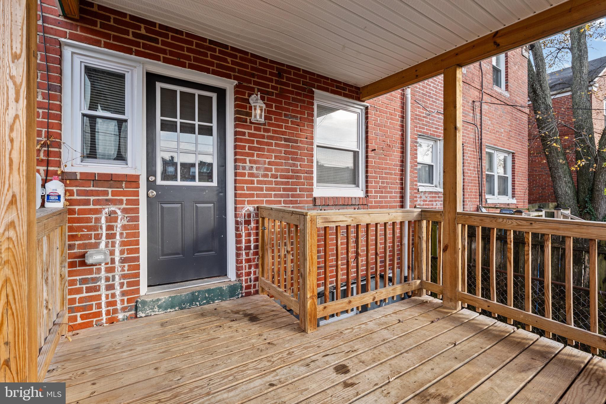 4139 Mountwood Road Baltimore, MD 21229 - Photo 52 of 53 a view of a brick house with large windows
