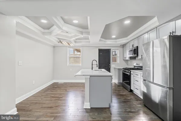 a kitchen with stainless steel appliances a refrigerator stove microwave and cabinets