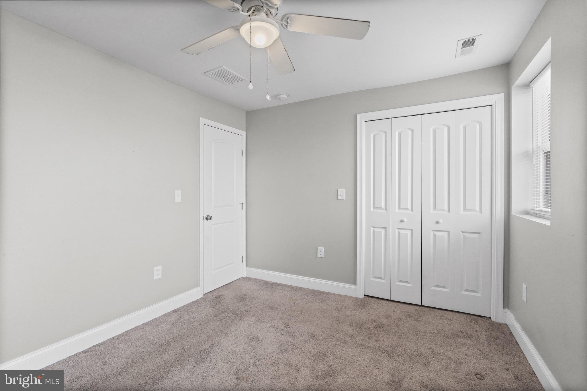 4139 Mountwood Road Baltimore, MD 21229 - Photo 10 of 53 an empty room with a chandelier fan