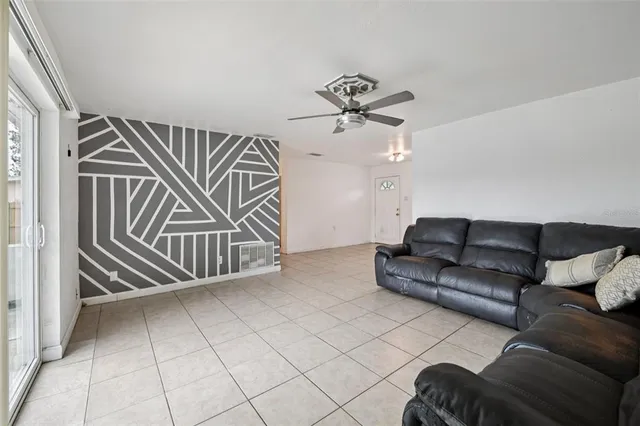 a living room with a couch and a chandelier