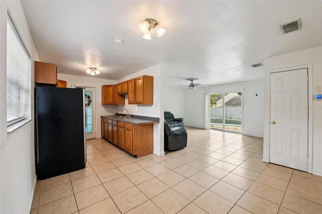 a kitchen with stainless steel appliances a refrigerator and a stove top oven