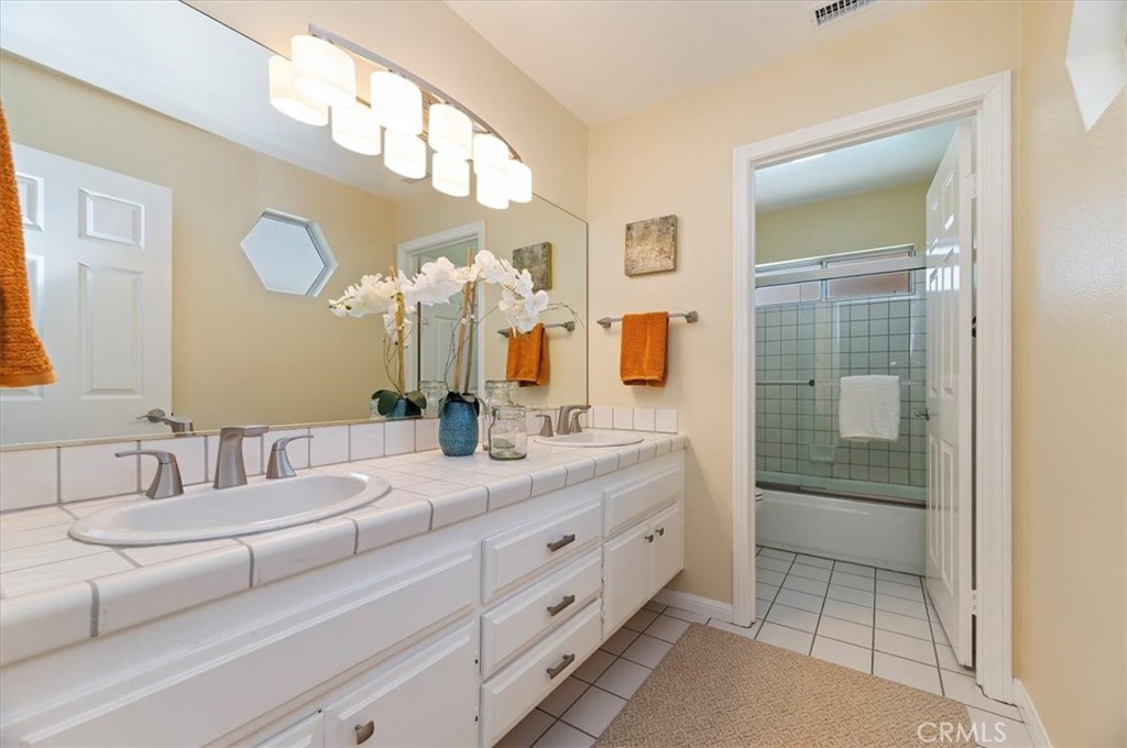 43966 Highlander Drive Temecula, CA 92592 - Photo 21 of 33 a bathroom with a double vanity sink and a mirror