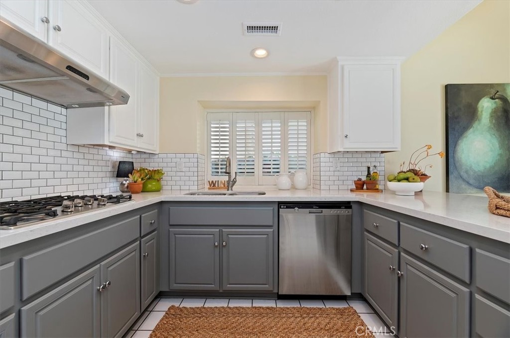 43966 Highlander Drive Temecula, CA 92592 - Photo 8 of 33 a kitchen with a sink stove cabinets and window