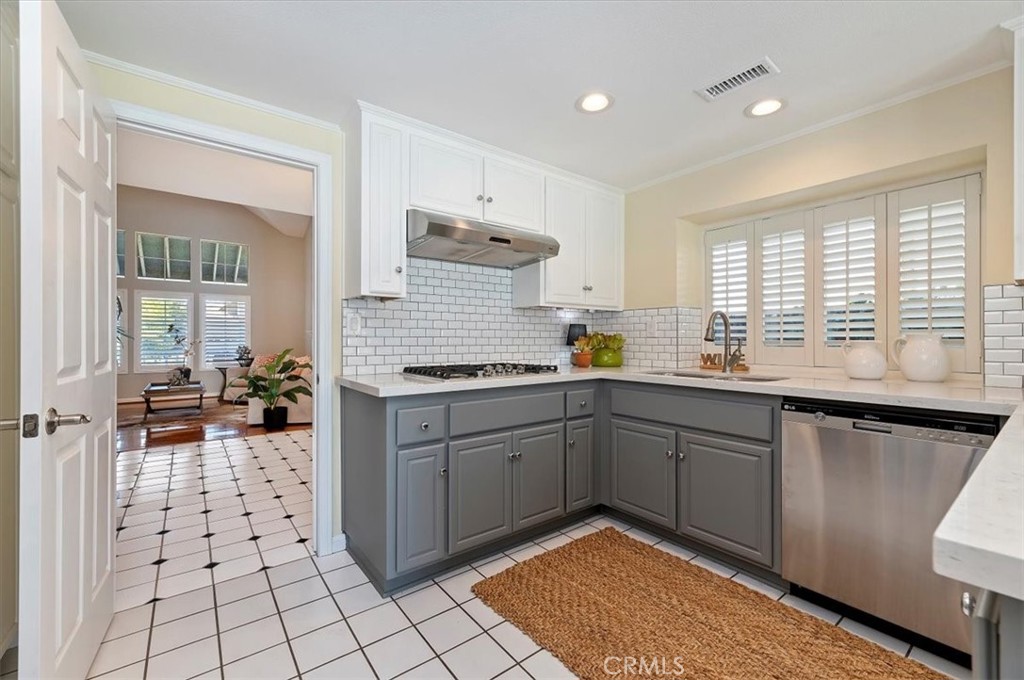 43966 Highlander Drive Temecula, CA 92592 - Photo 9 of 33 a kitchen with a sink stove and cabinets