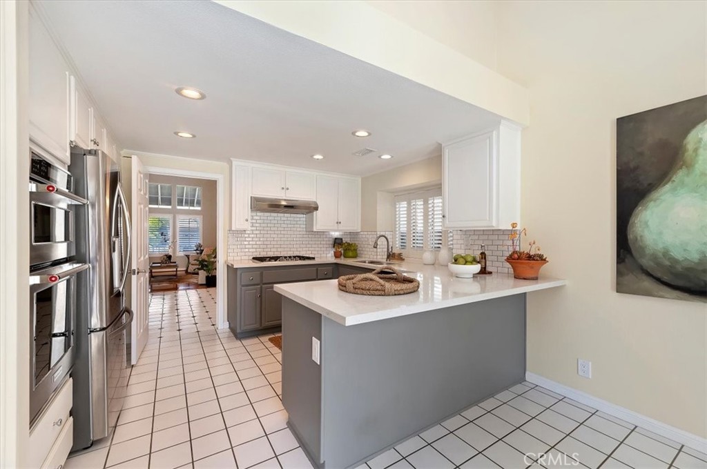 43966 Highlander Drive Temecula, CA 92592 - Photo 10 of 33 a kitchen with stainless steel appliances a sink stove and cabinets