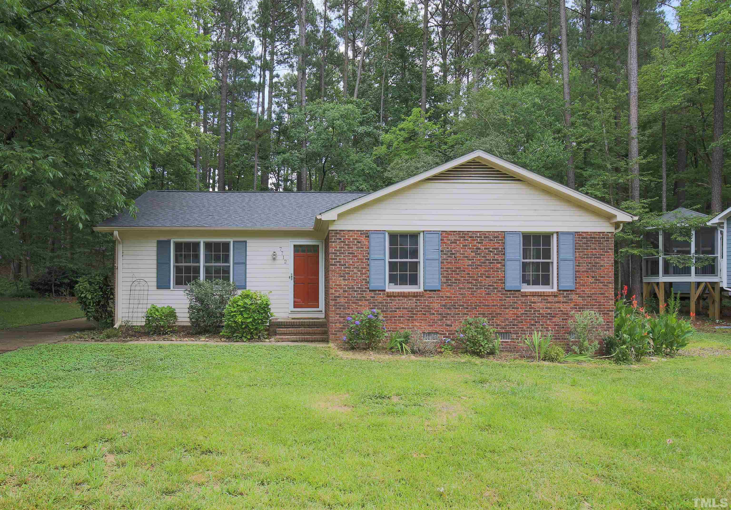 7712 Cart Track Trail Raleigh, NC 27615 - Photo 1 of 11 a front view of a house with garden