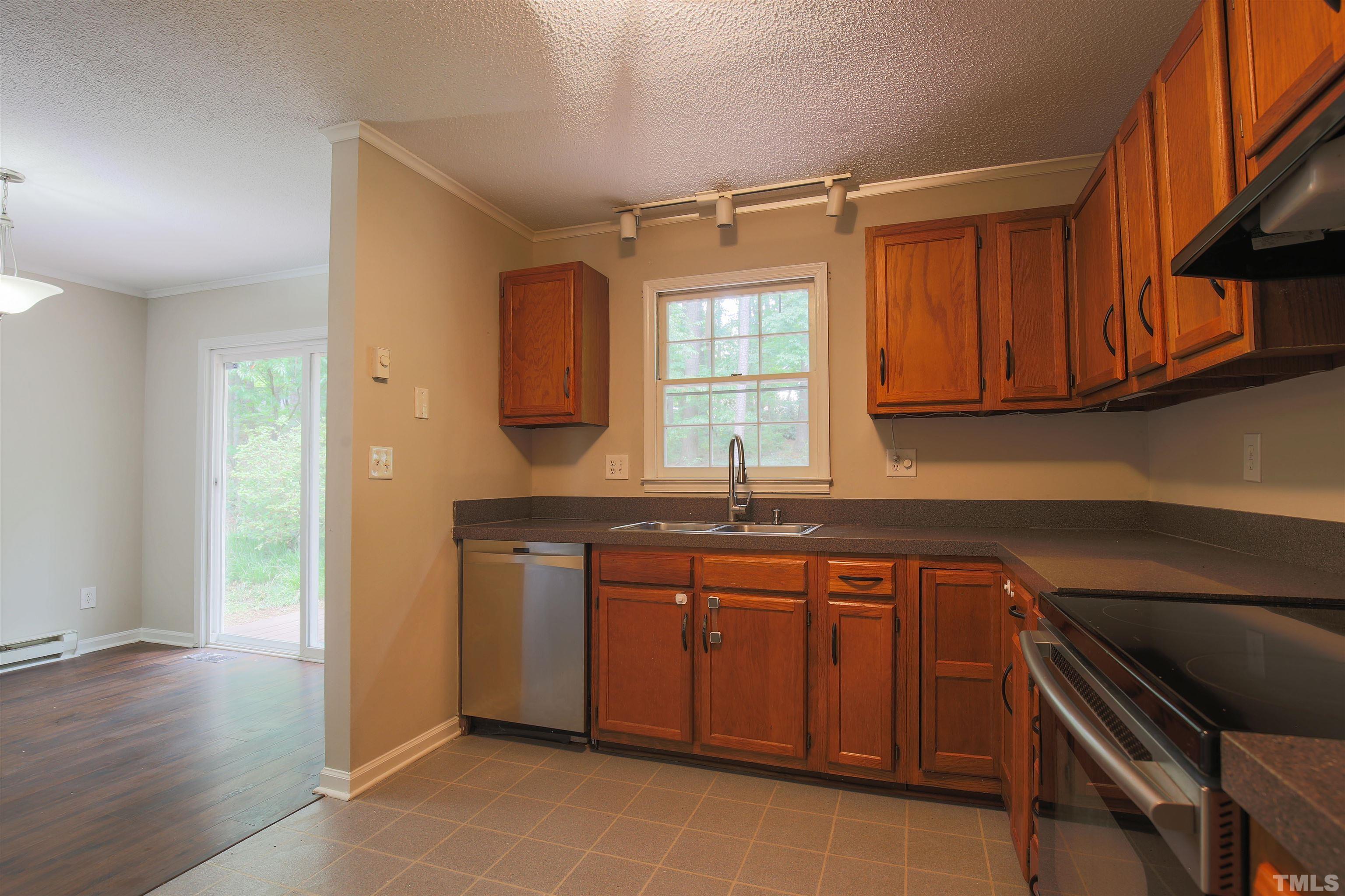 7712 Cart Track Trail Raleigh, NC 27615 - Photo 3 of 11 a kitchen with a sink cabinets and appliances