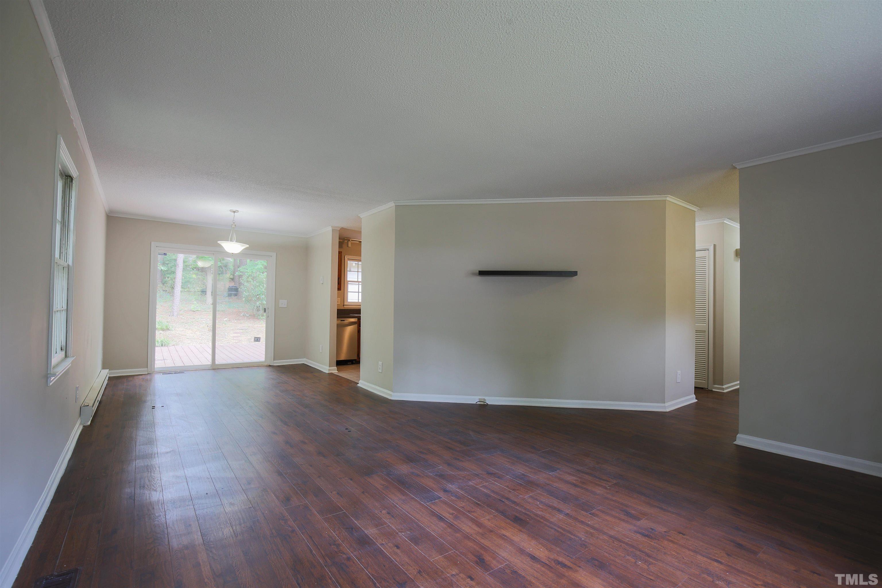 7712 Cart Track Trail Raleigh, NC 27615 - Photo 5 of 11 an empty room with wooden floor and windows