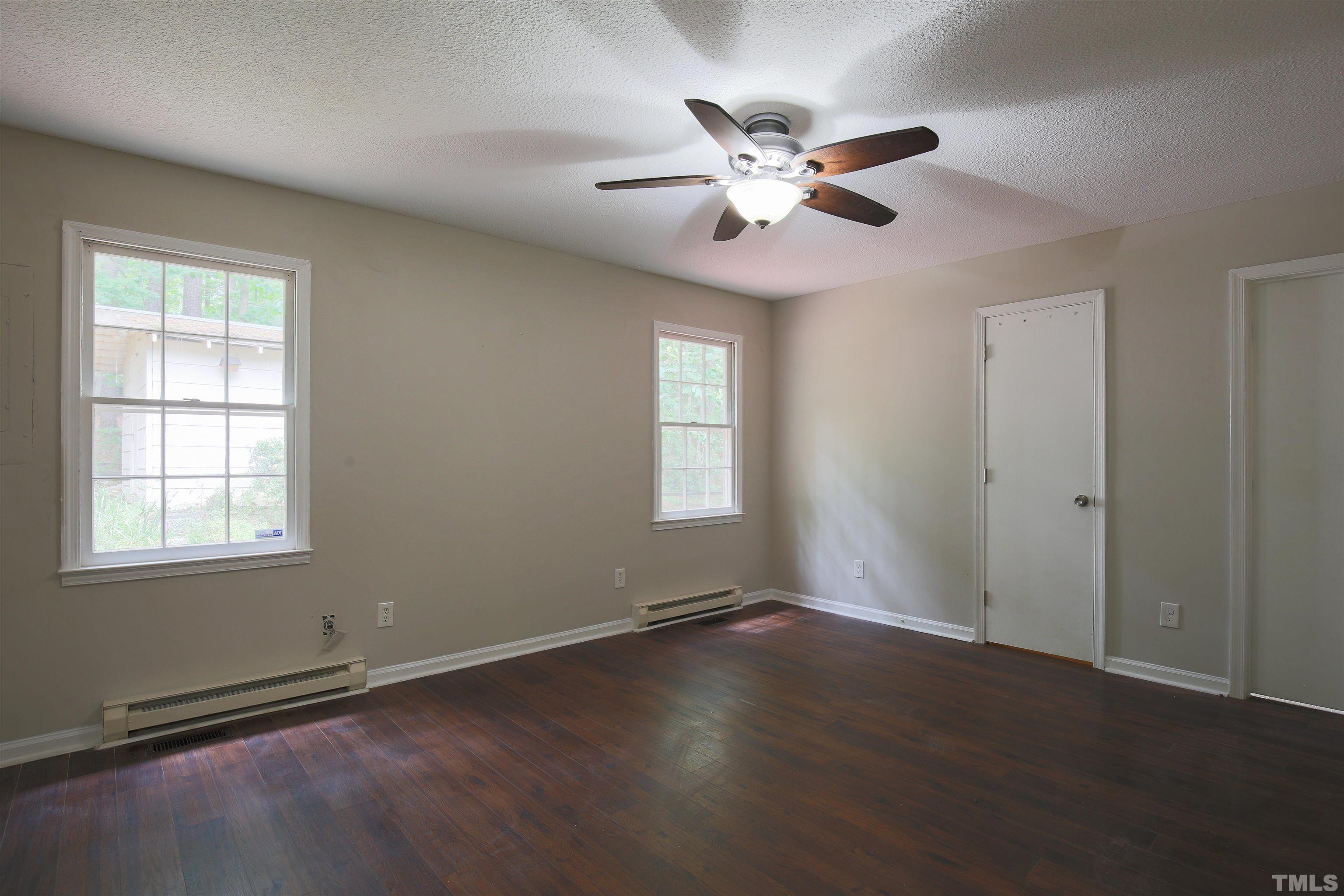7712 Cart Track Trail Raleigh, NC 27615 - Photo 6 of 11 a view of an empty room with wooden floor and a window