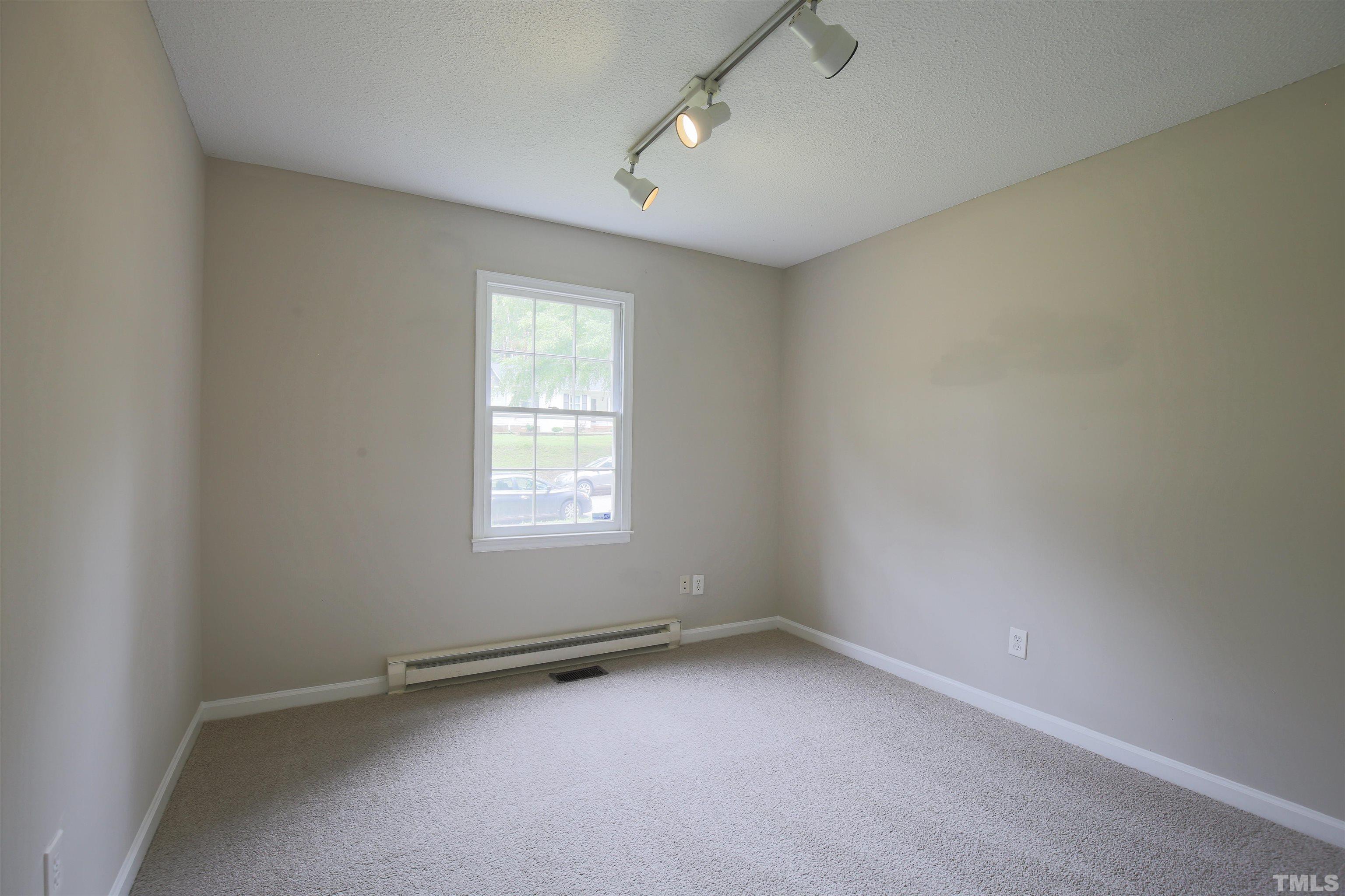 7712 Cart Track Trail Raleigh, NC 27615 - Photo 9 of 11 an empty room with a window