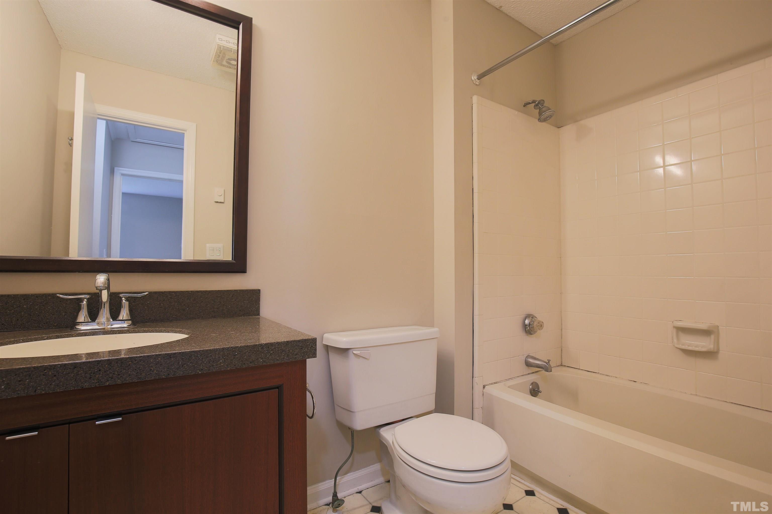 7712 Cart Track Trail Raleigh, NC 27615 - Photo 10 of 11 a bathroom with a granite countertop sink toilet and shower