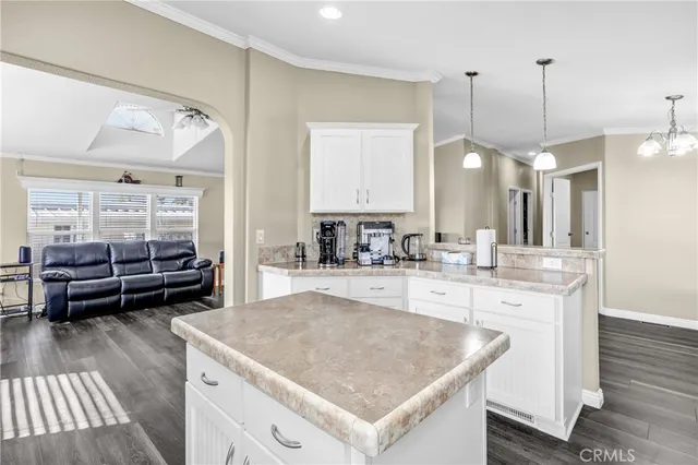 a kitchen with a stove a sink a dining table and chairs