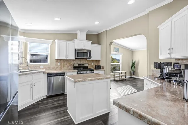 a kitchen with sink a stove and cabinets