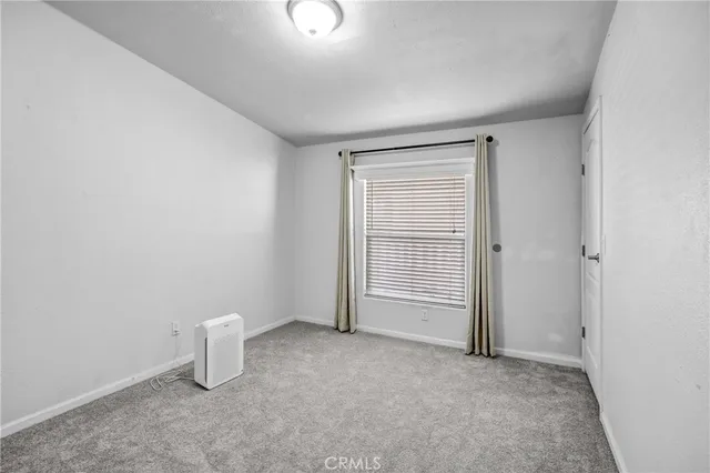 an empty room with a fireplace