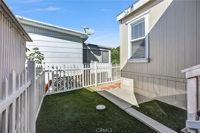 a view of a house with wooden fence