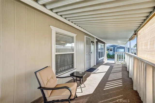 a view of a patio with table and chairs with wooden floor and fence