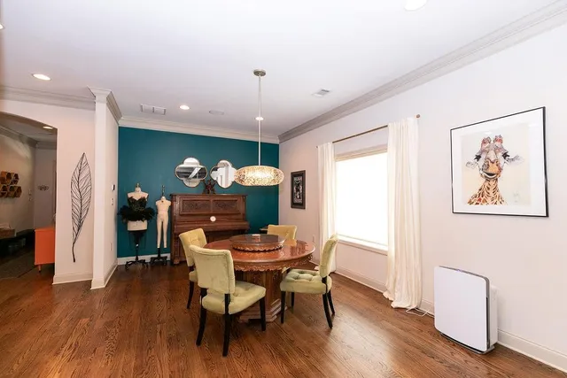 a dining room with furniture and wooden floor