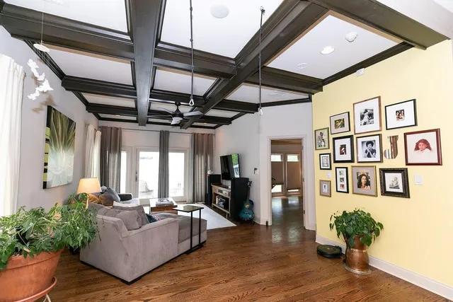 a living room with furniture and wooden floor