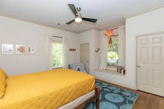 a bedroom with a bed and wooden floor