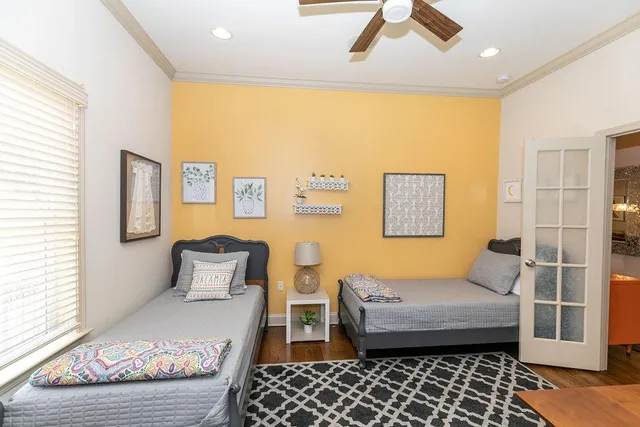 a bedroom with a bed and wooden floor