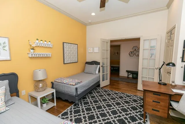 a spacious bathroom with a double vanity sink a mirror and a toilet