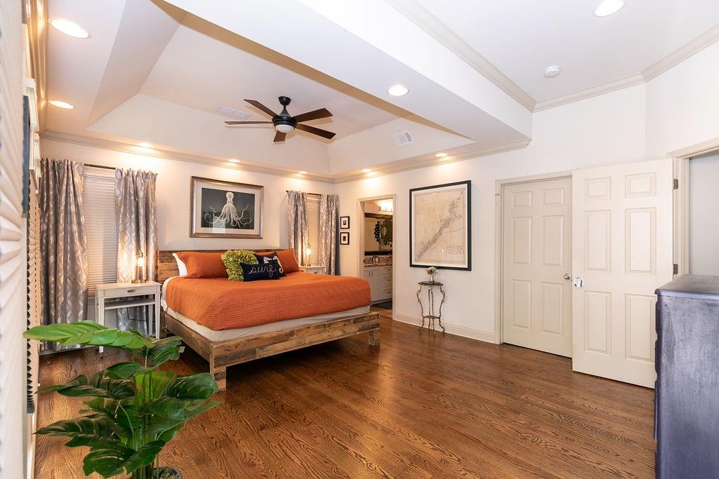 1084 Sanders Avenue Southeast, Unit A Atlanta, GA 30316 - Photo 33 of 44 a spacious bedroom with a bed chandelier and a window