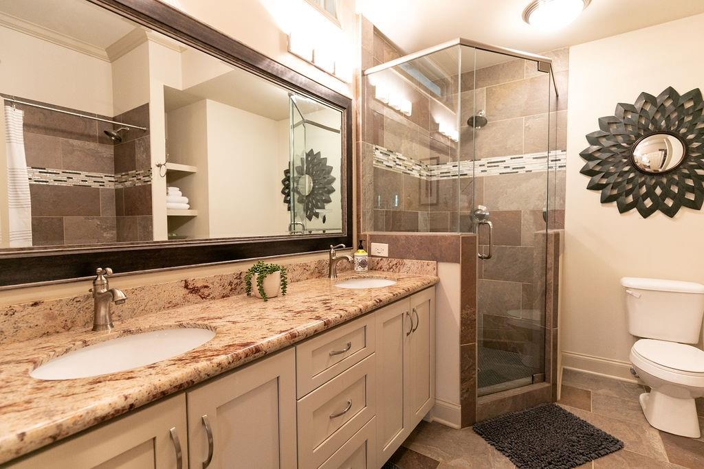 1084 Sanders Avenue Southeast, Unit A Atlanta, GA 30316 - Photo 38 of 44 a bathroom with a granite countertop sink mirror and toilet